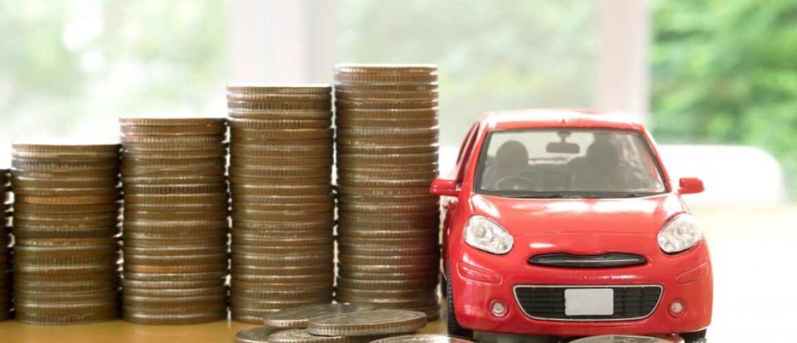 red car over a lot of stacked coins